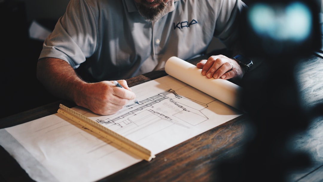 Architect reviewing construction plans at a work table