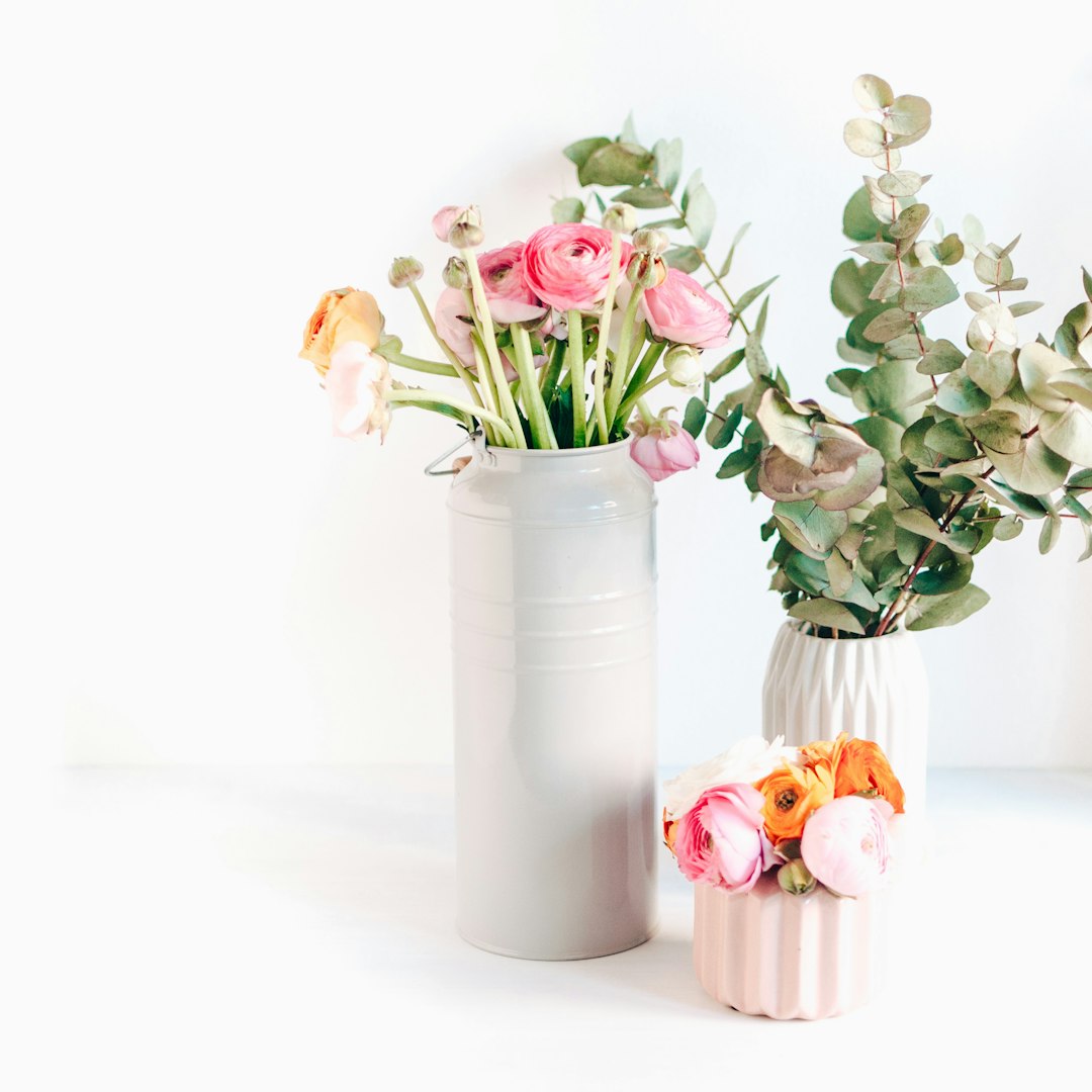 Two floral arrangements displayed in vases