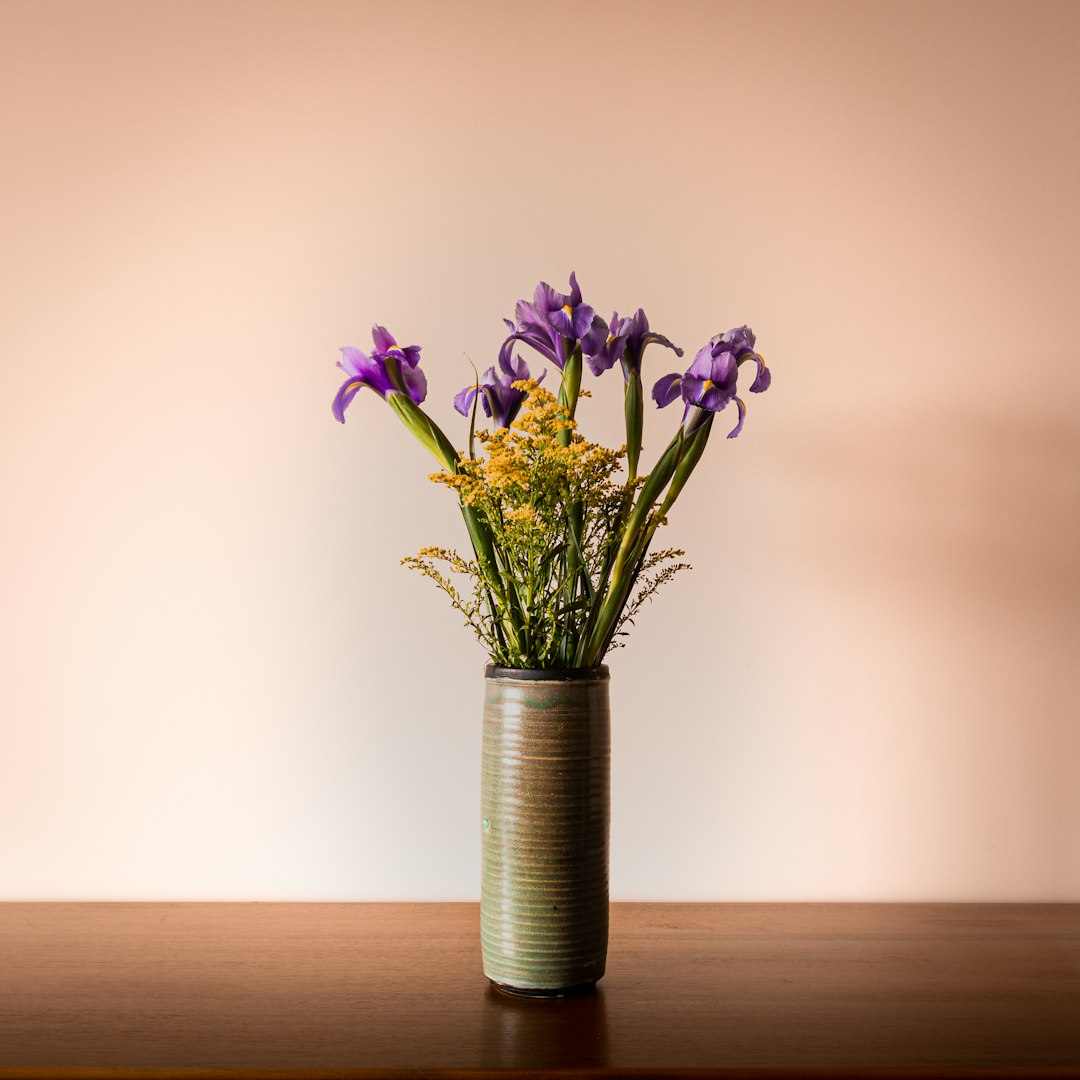 Purple floral arrangement in a gray vase
