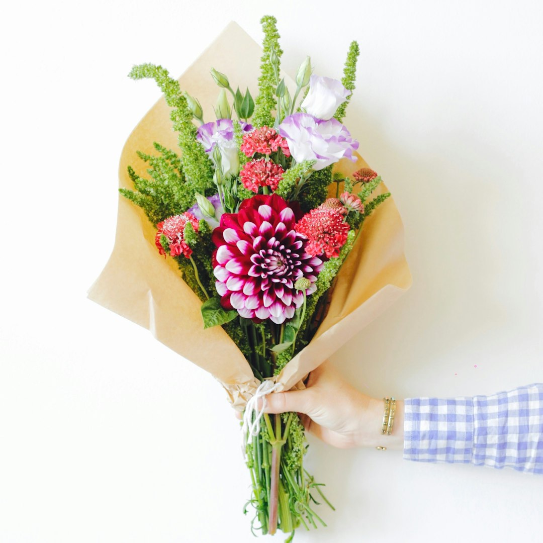 Neutral bouquet of flowers wrapped in paper