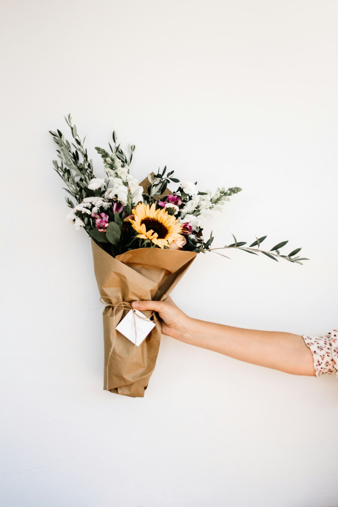 Person holding a fresh flower bouquet