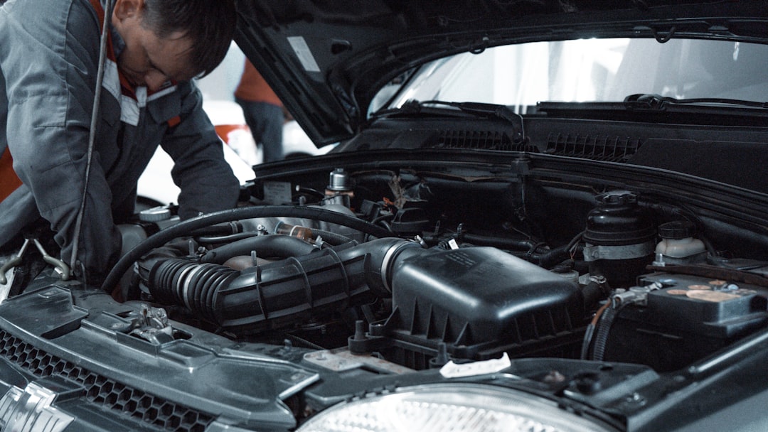 Mechanic inspecting a vehicle engine bay