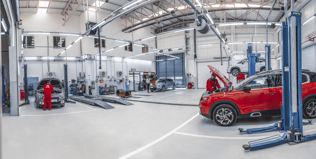 Mechanics working in a bright automotive repair shop