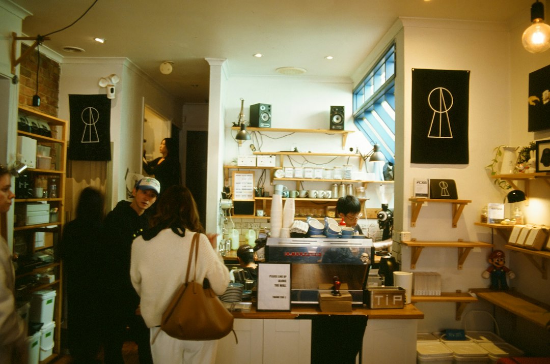Customers ordering at a neighborhood coffee shop counter