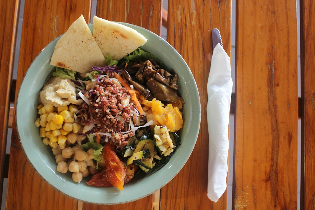 Colorful grain salad with vegetables and hummus