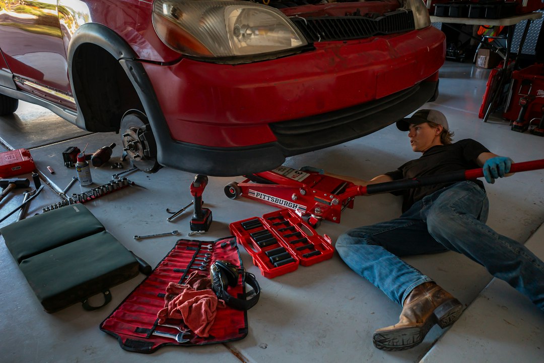 Auto body technician working on a vehicle in a collision repair shop