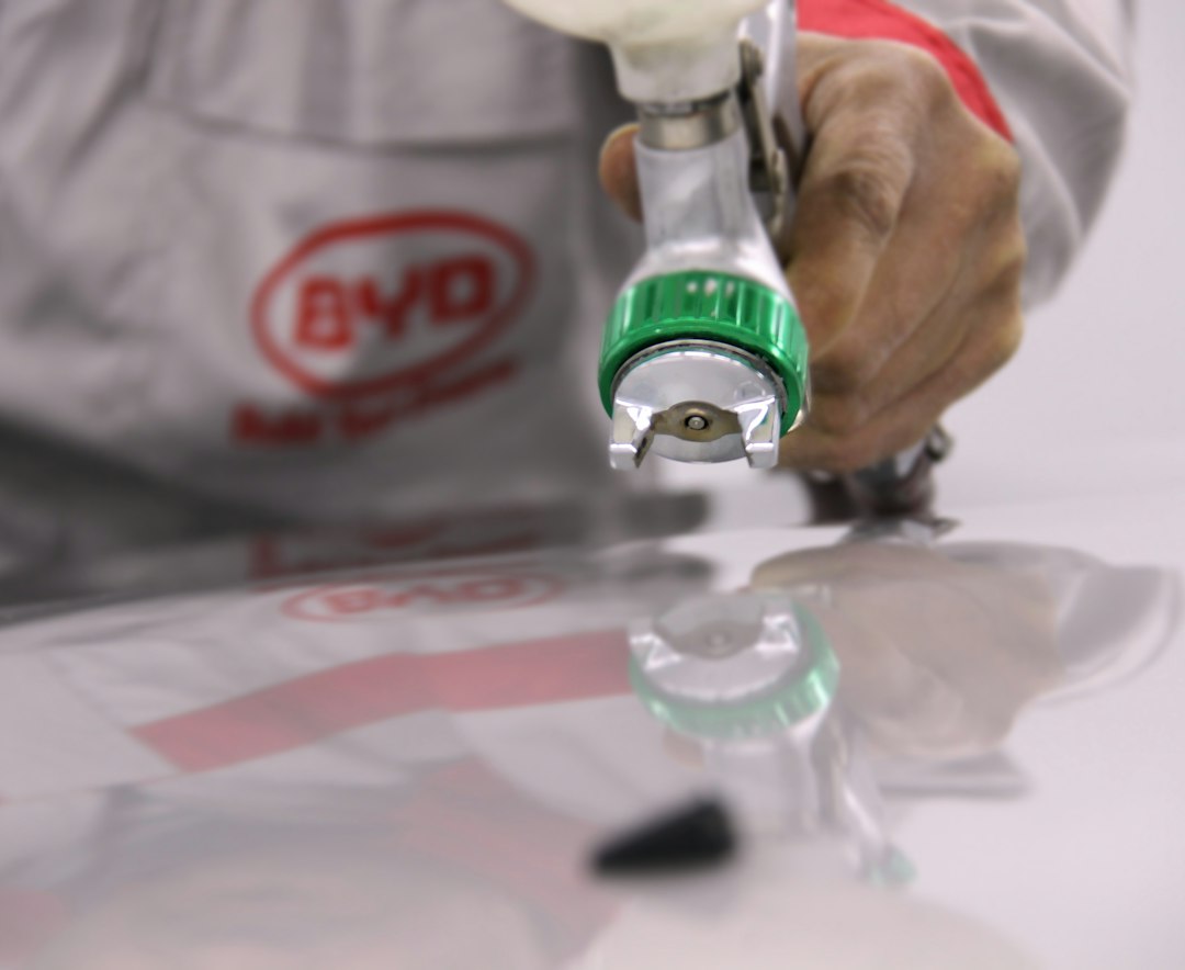 Technician performing close bodywork on a vehicle panel