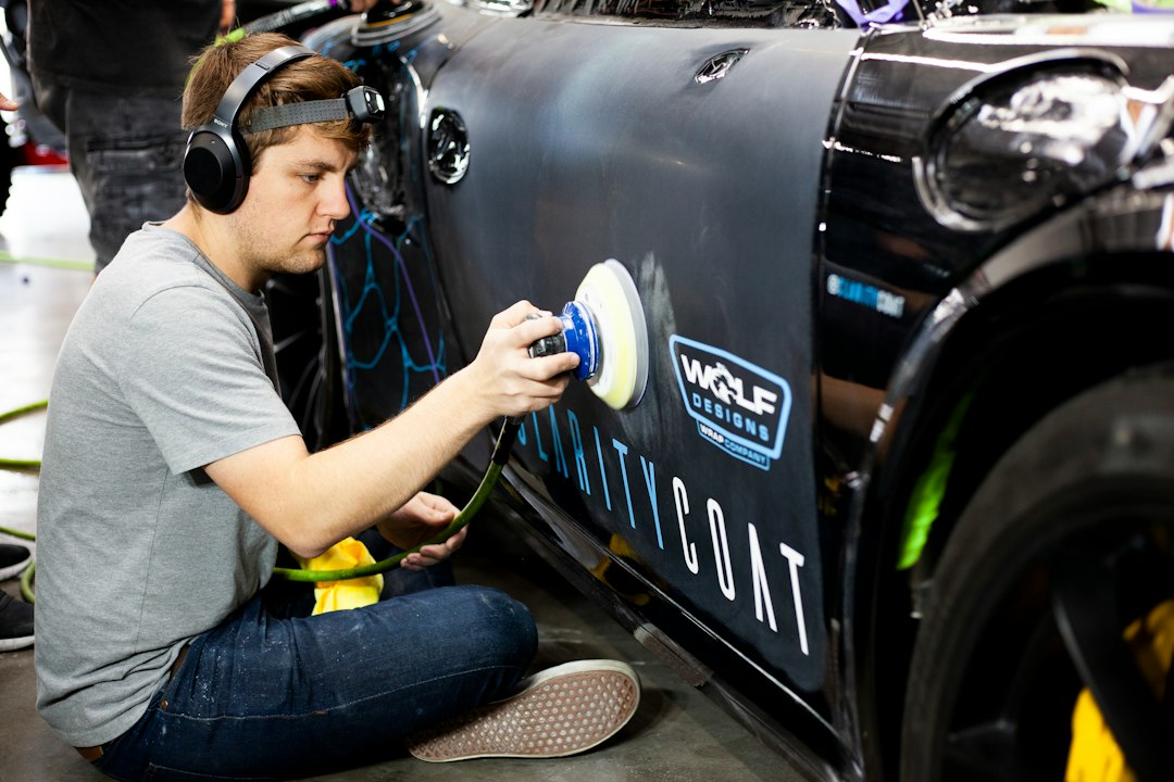Automotive body panel being sanded and prepared for refinishing