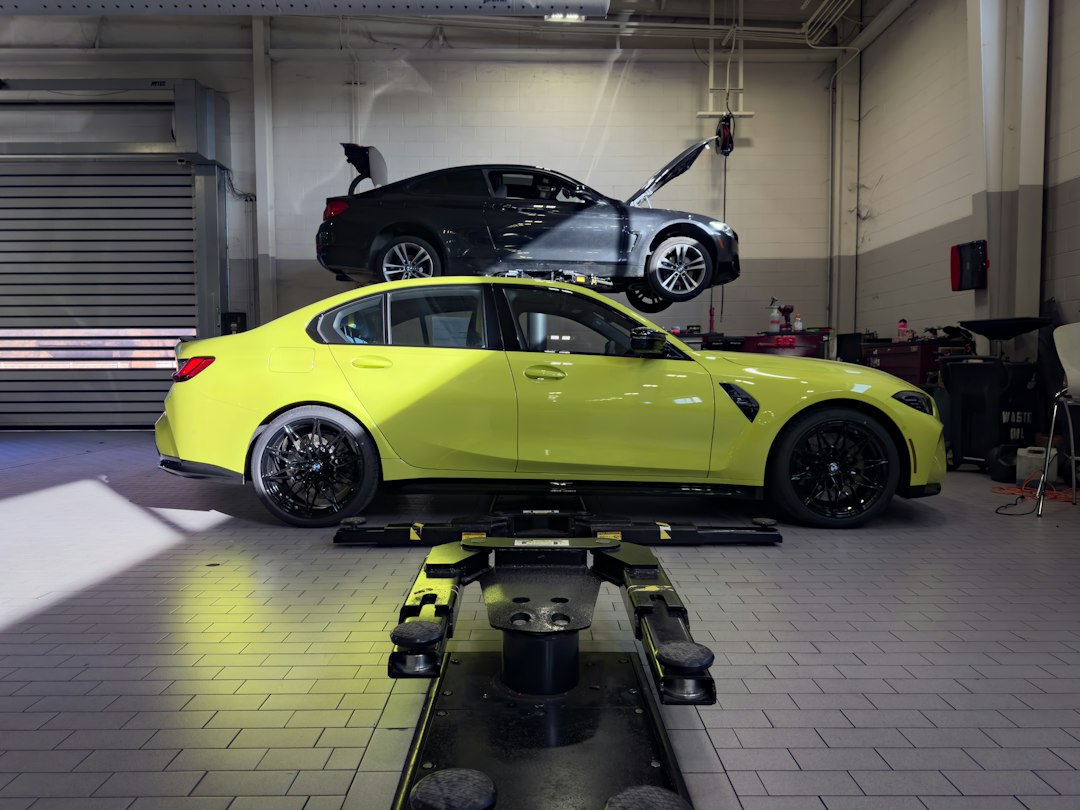 Vehicle undergoing structural collision repair in a garage