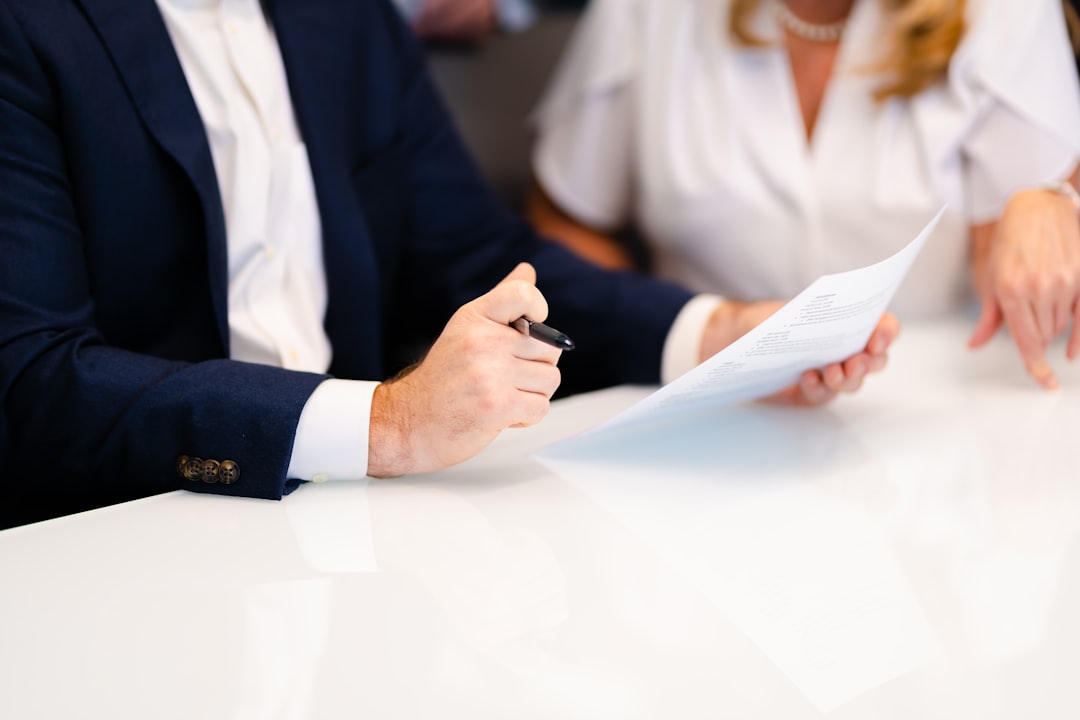 Two people discussing documents at a table
